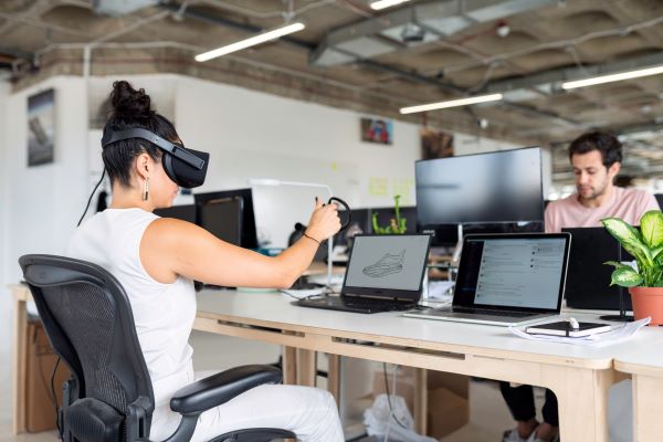 woman-in-white-tank-top-using-black-laptop-computer-with-vr 