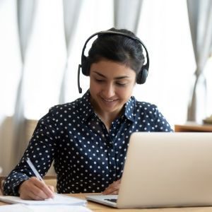 female-with-headphones-making-notes
