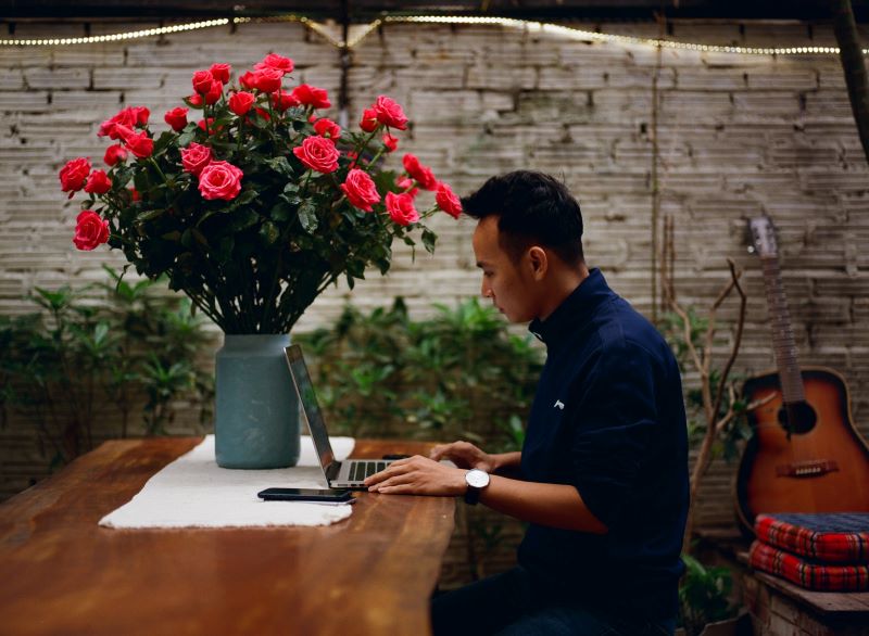 male-in-flower-shop-at-laptop 