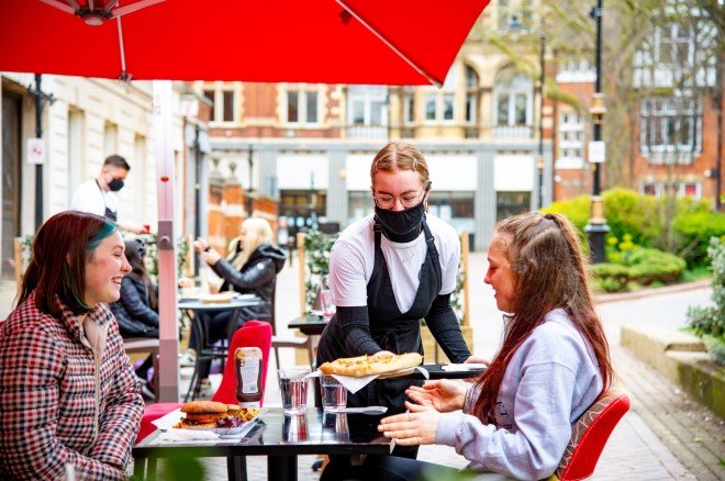 people being served at an outdoor cafe 