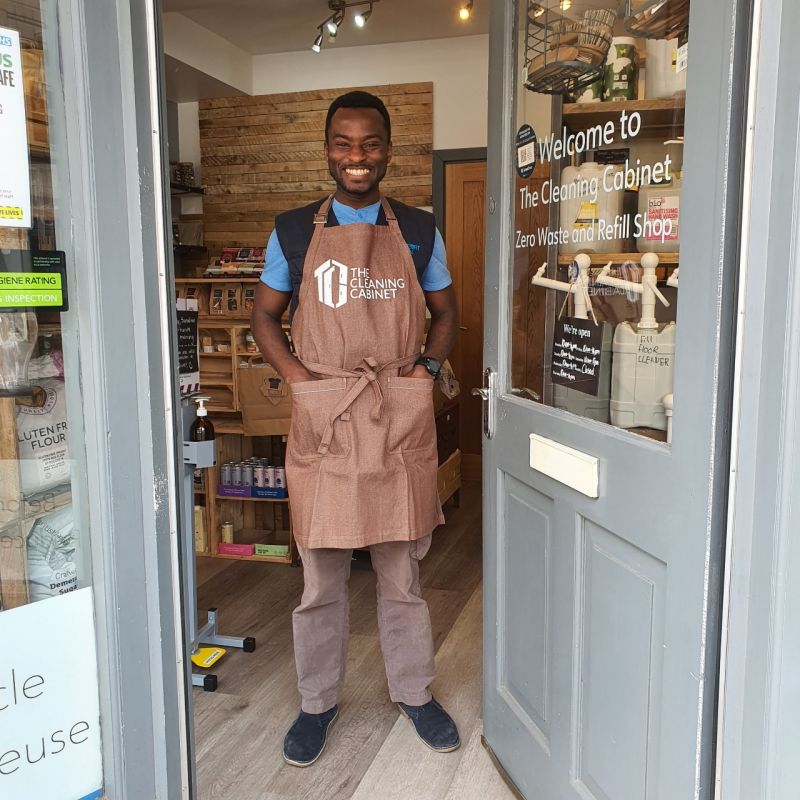 a man standing in his shop doorway