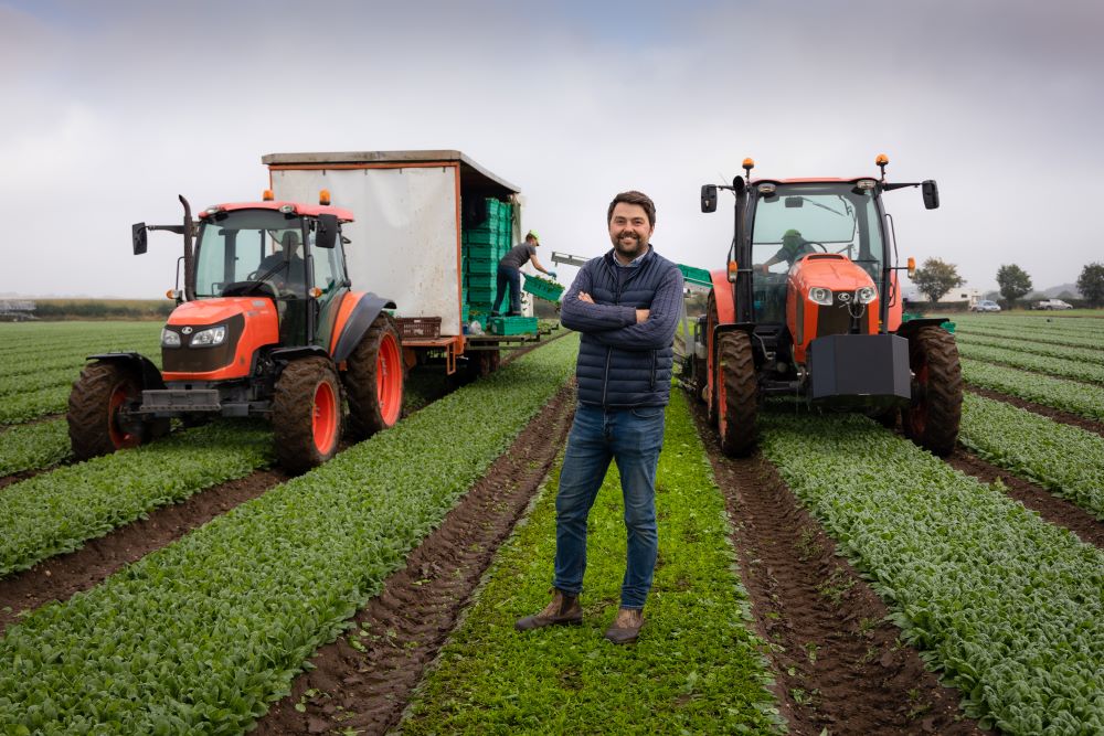 Adam-Lockwood-in-field-with-two-tractors-behind