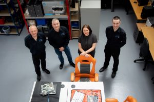 Four-people-looking-up-in-warehouse-UKBITS