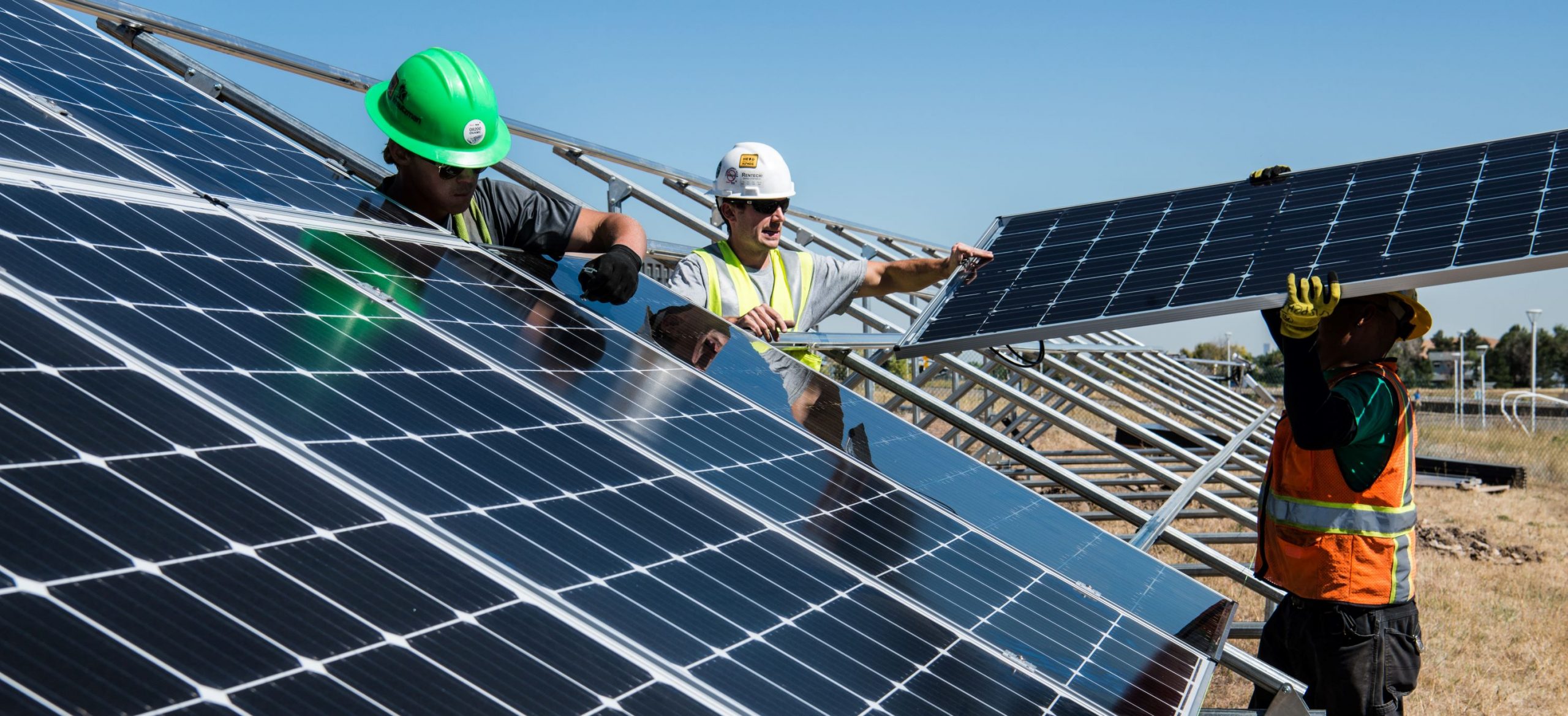 men fitting solar panels