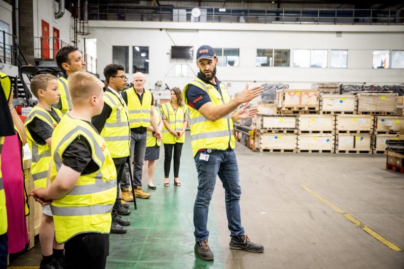Business Benefits showing young people in a logistics warehouse 