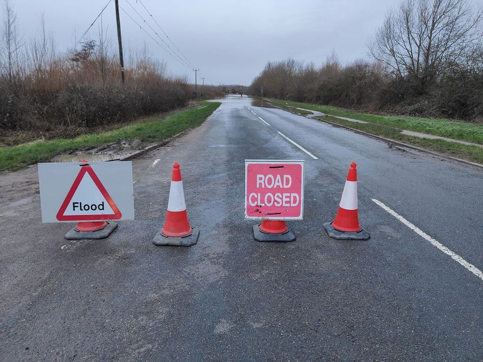a road with a stop signes because of a flood 